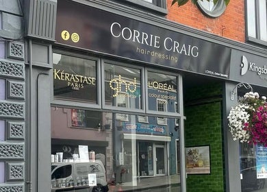 Exterior of Rebekah Whiteside Hair in Donaghadee, Northern Ireland, GB with stylish signage and floral decor.