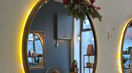 Warm-lit mirror at Rebekah Whiteside Hair, Donaghadee, Northern Ireland, GB, showcasing cozy decor.