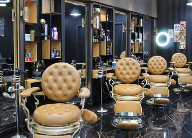 Luxurious barber chairs at Tiger Gents Salon, Dubai, AE with modern decor and organized workspace.