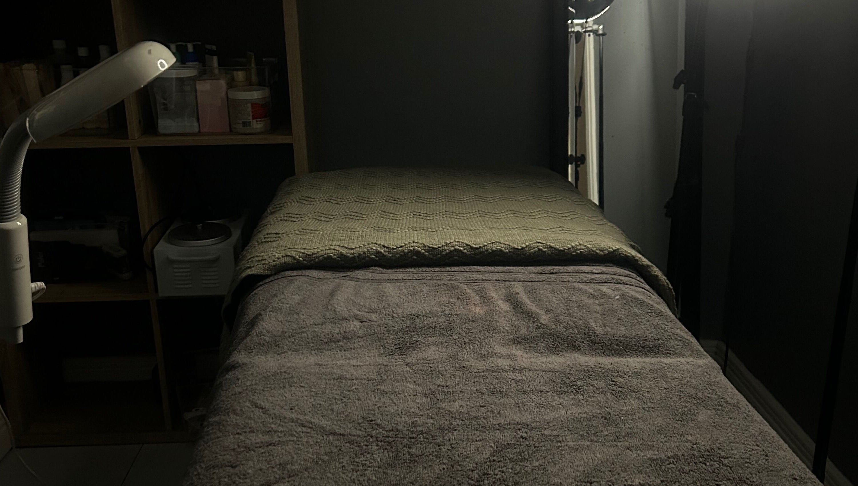 Relaxing massage room at Sknthetic Studio, Portmore, St. Catherine Parish, JM with ambient lighting.