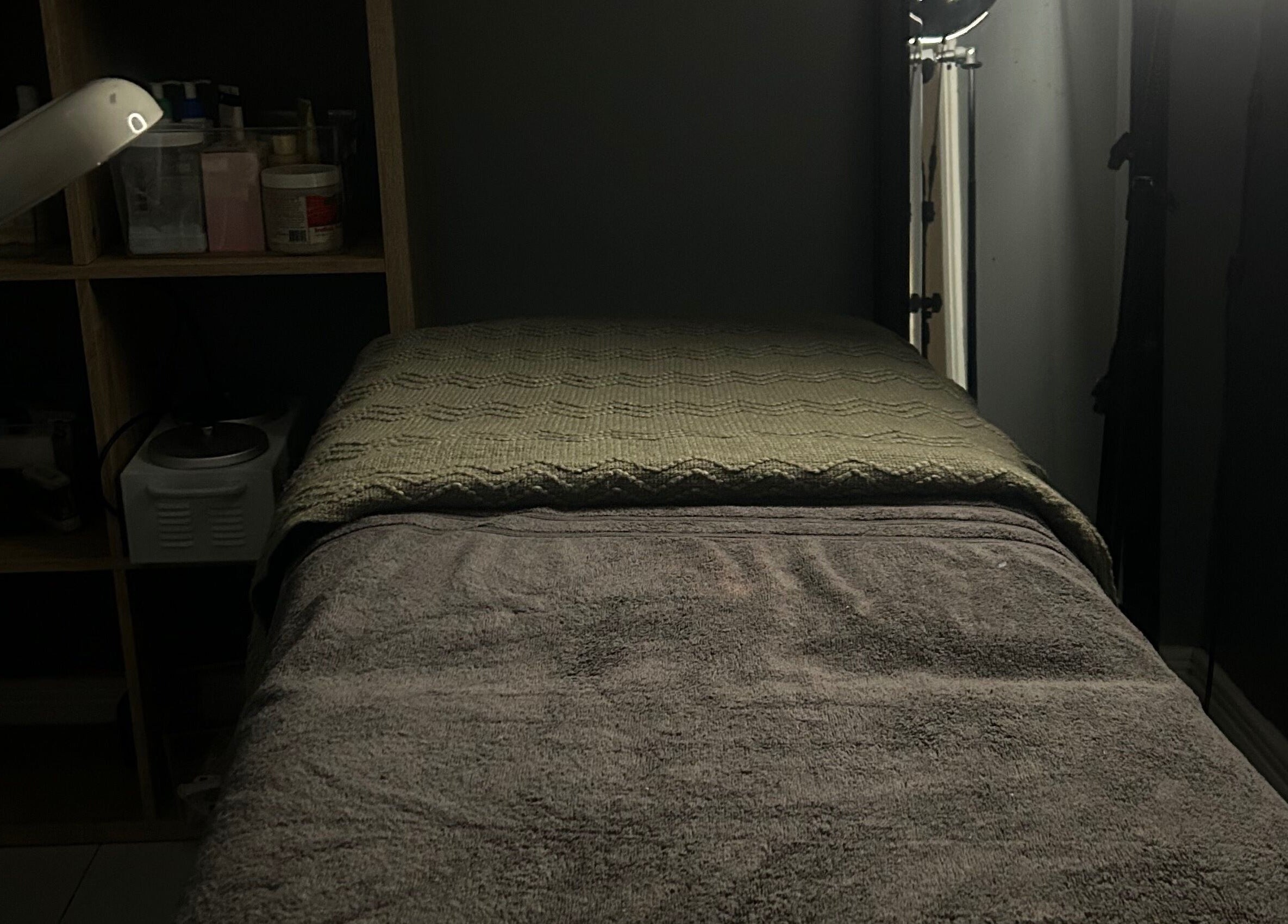 Relaxing massage room at Sknthetic Studio, Portmore, St. Catherine Parish, JM with ambient lighting.