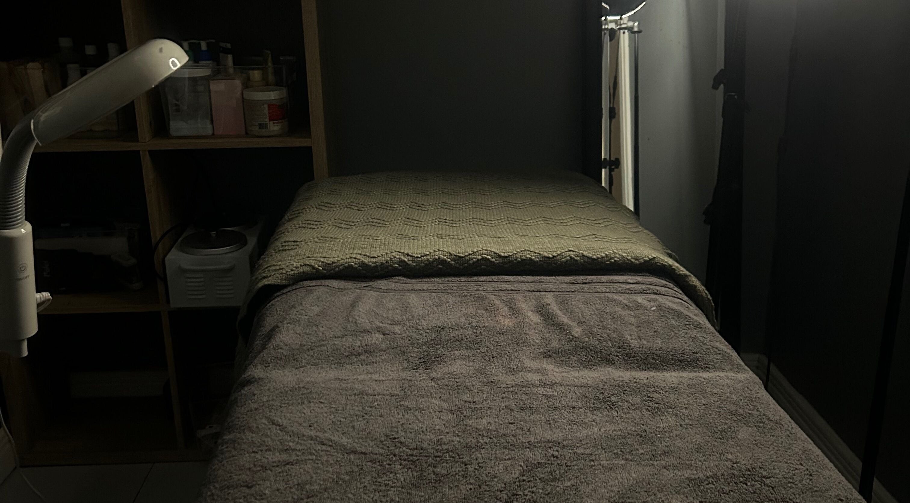 Relaxing massage room at Sknthetic Studio, Portmore, St. Catherine Parish, JM with ambient lighting.