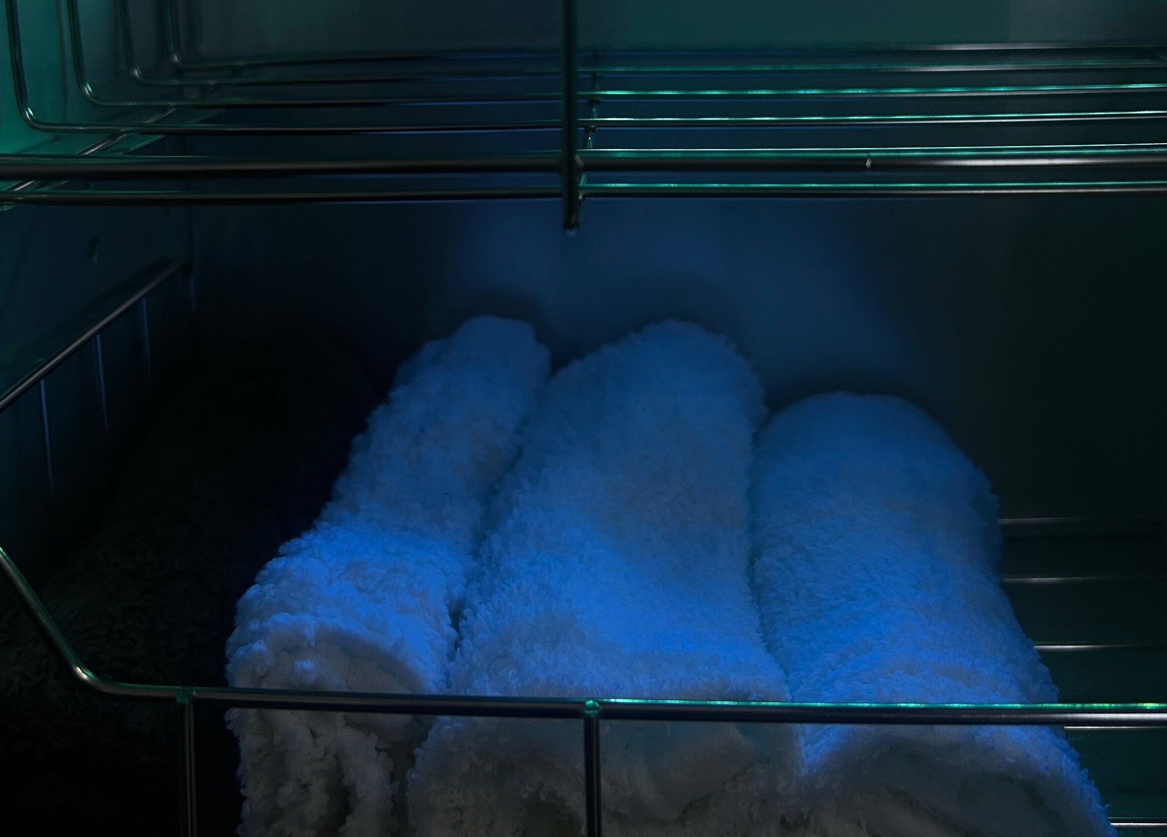 Neatly rolled towels in calming light at Sknthetic Studio, Portmore, St. Catherine Parish, JM.