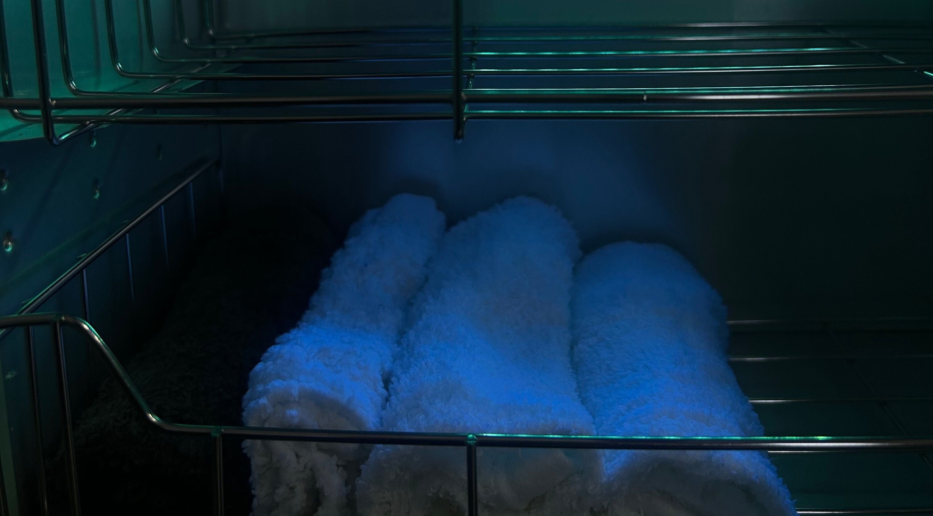 Neatly rolled towels in calming light at Sknthetic Studio, Portmore, St. Catherine Parish, JM.