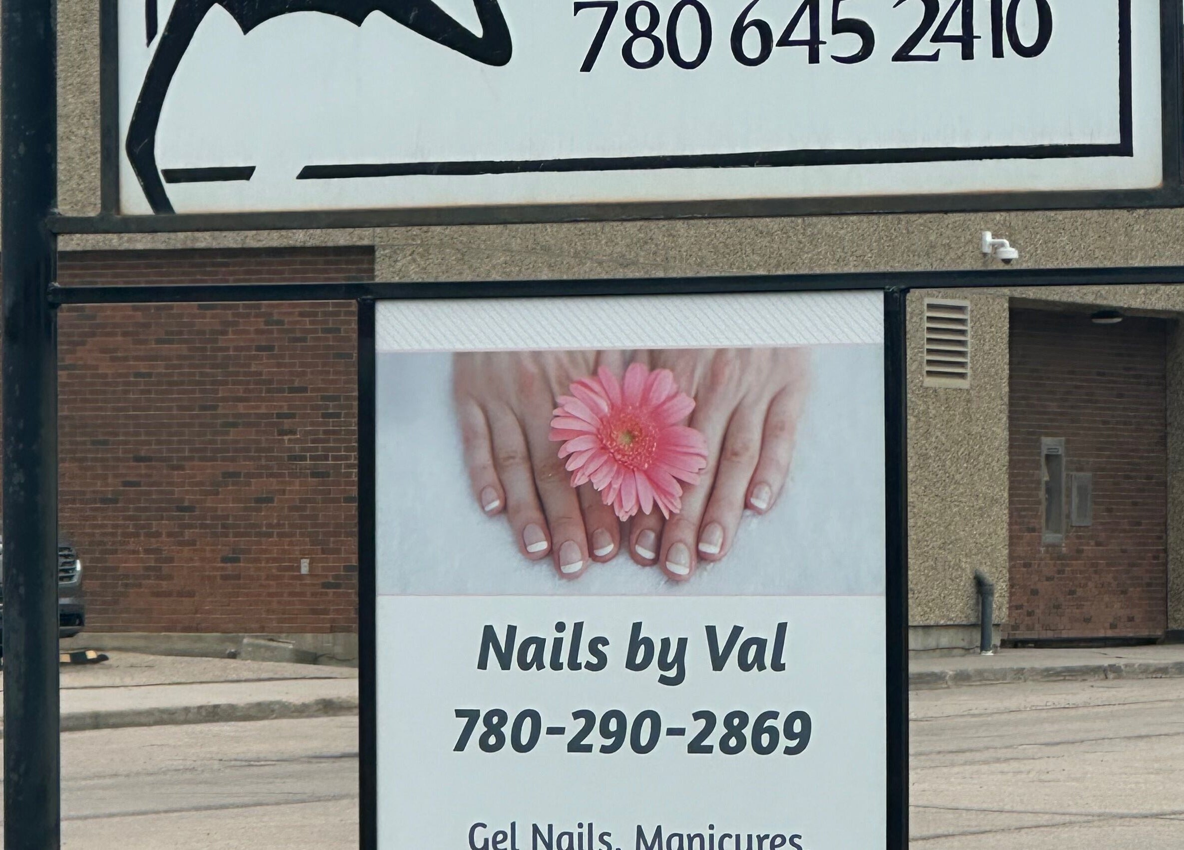 Nails by Val sign with pink flower design in Saint Paul, Alberta, CA.