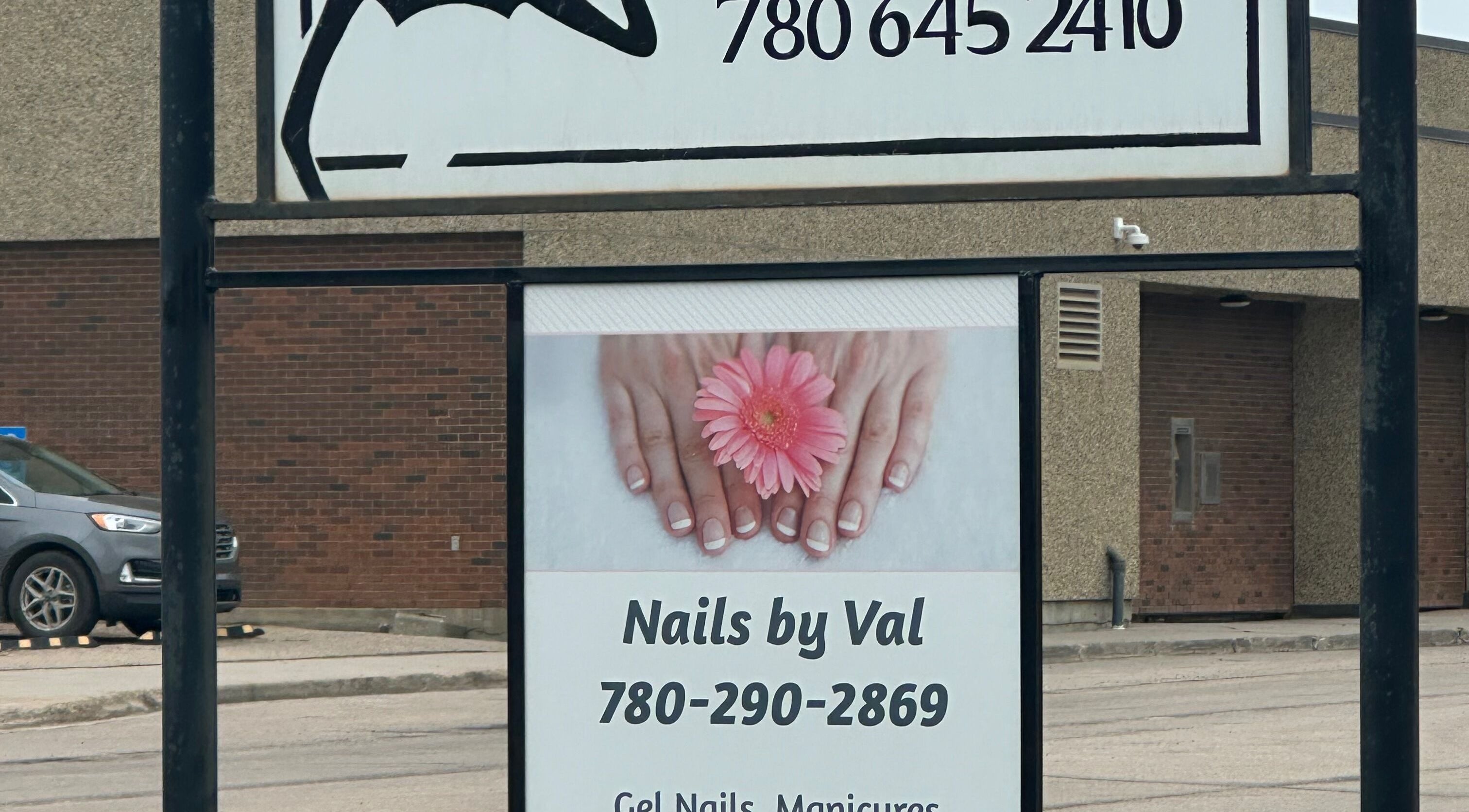 Nails by Val sign with pink flower design in Saint Paul, Alberta, CA.