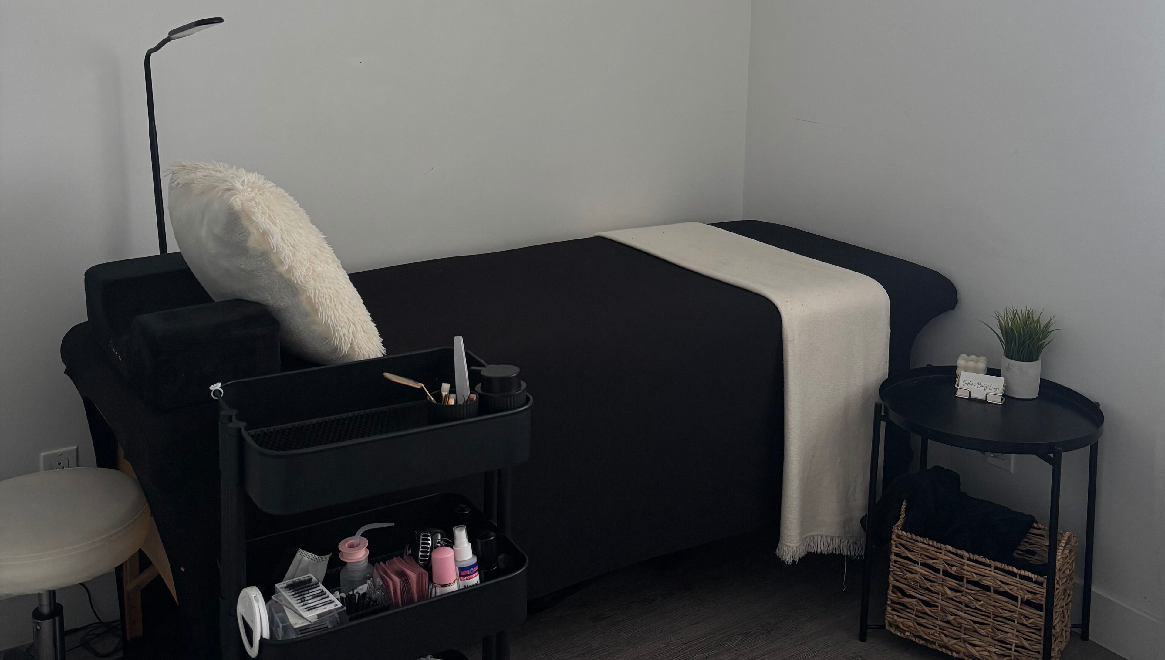 Cozy treatment bed at Sophie's Beauty Lounge in Longueuil, Québec, CA with modern decor and soft lighting.
