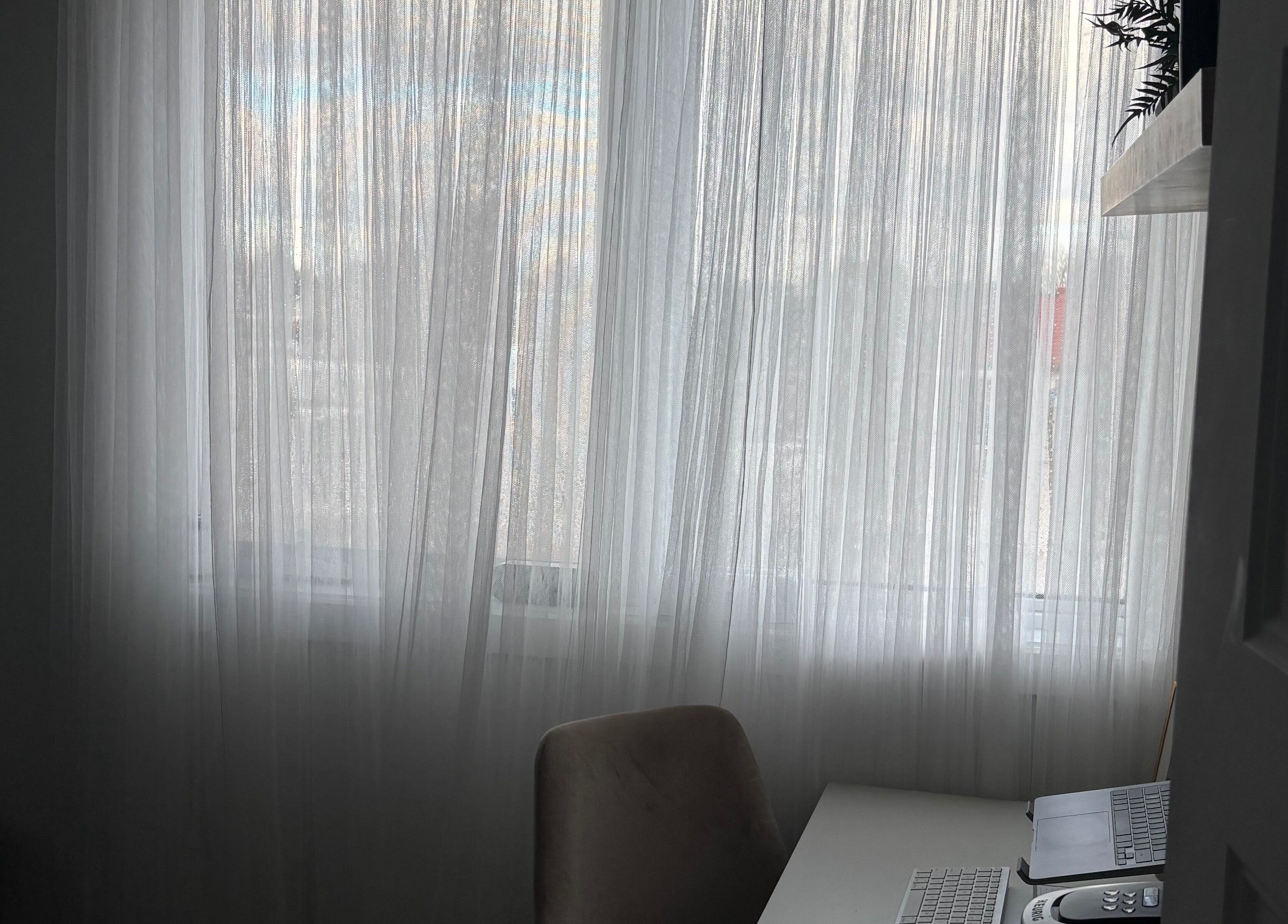 Bright, serene workspace at Sophie's Beauty Lounge, Longueuil, Québec, CA featuring soft white drapes.