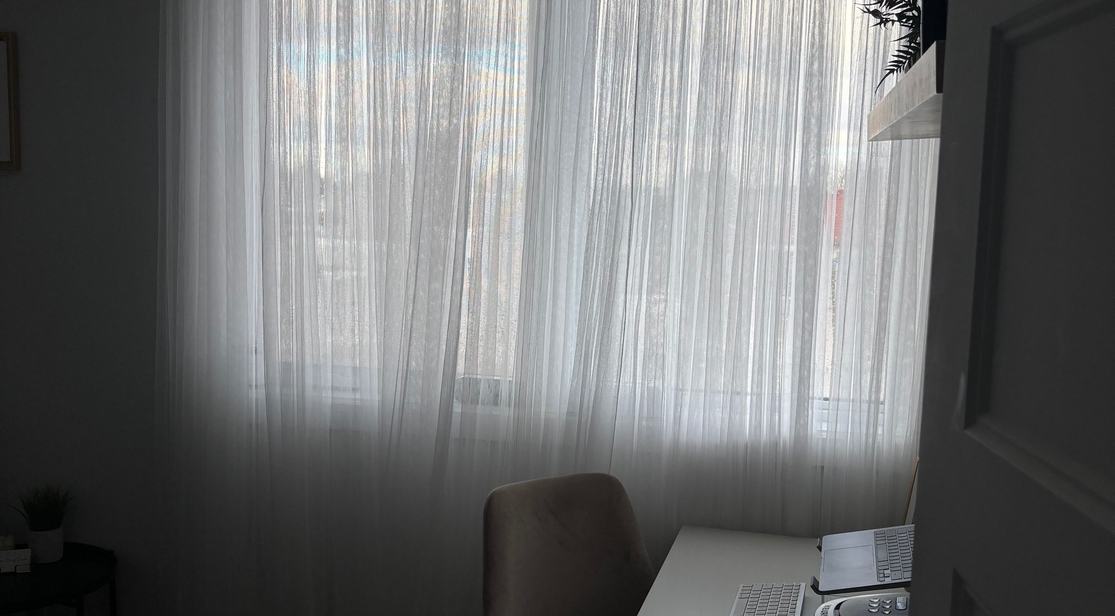 Bright, serene workspace at Sophie's Beauty Lounge, Longueuil, Québec, CA featuring soft white drapes.