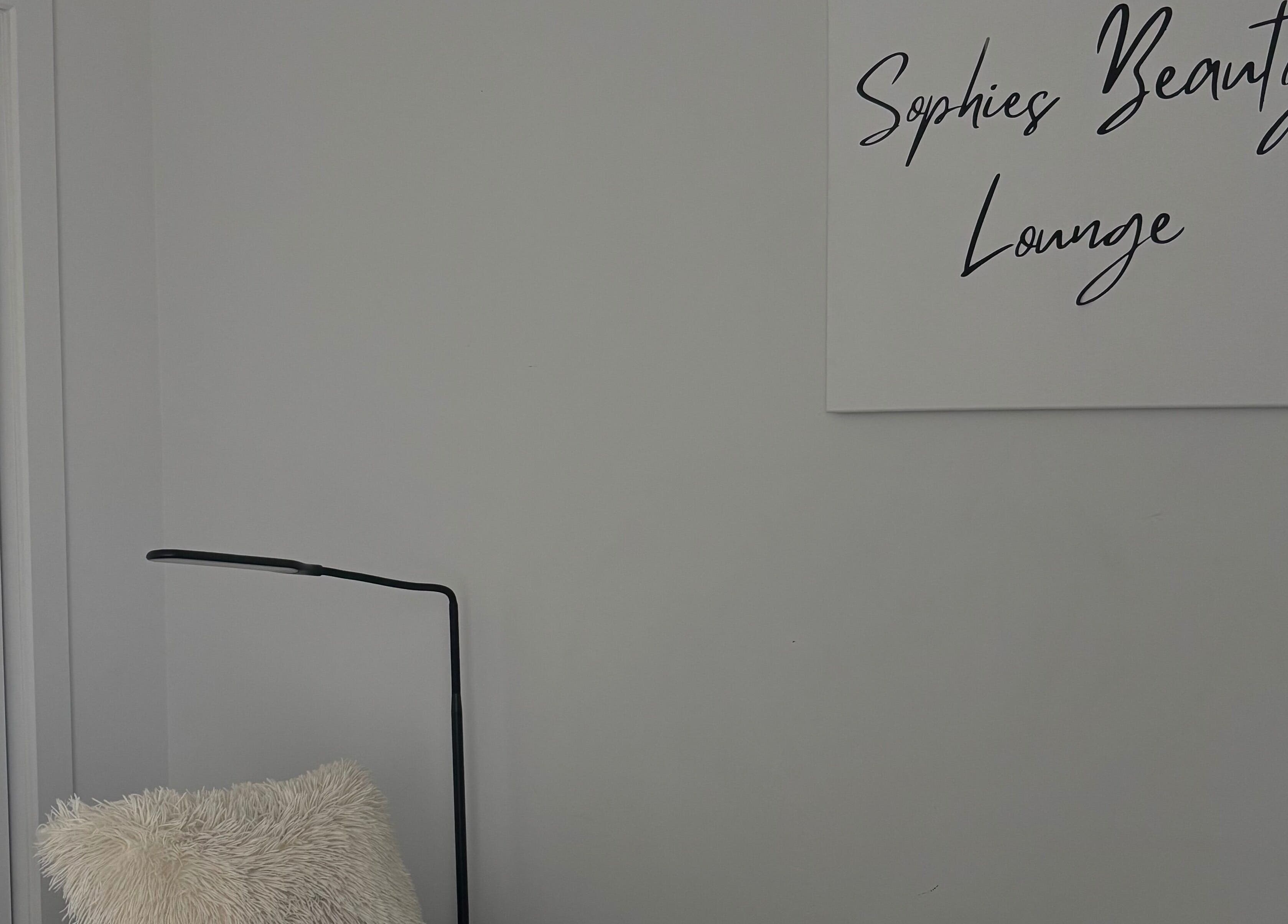 Cozy corner at Sophie's Beauty Lounge with plush chair and minimalist decor, Longueuil, Québec, CA.