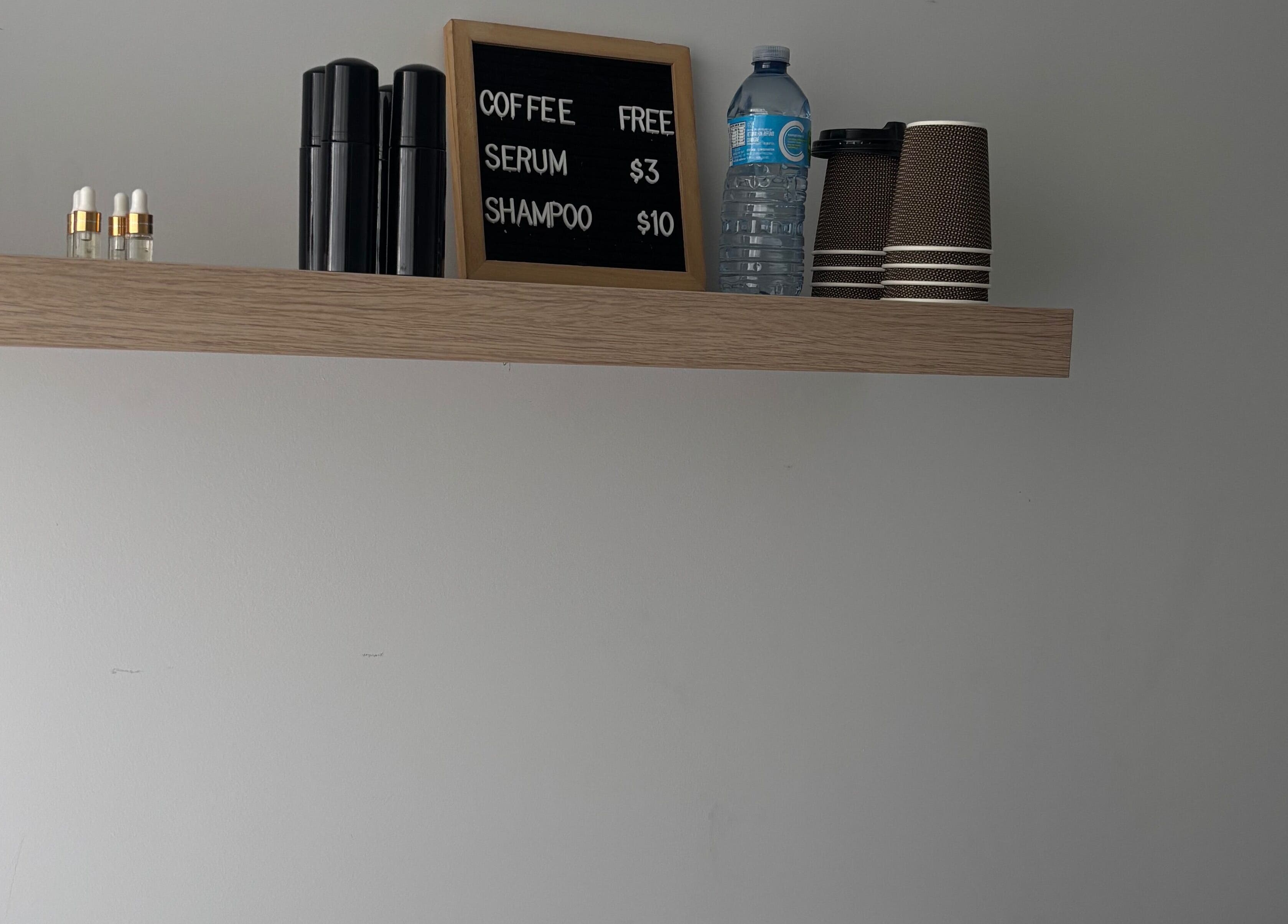 Stylish shelf with serums and coffee at Sophie's Beauty Lounge, Longueuil, Québec, CA.