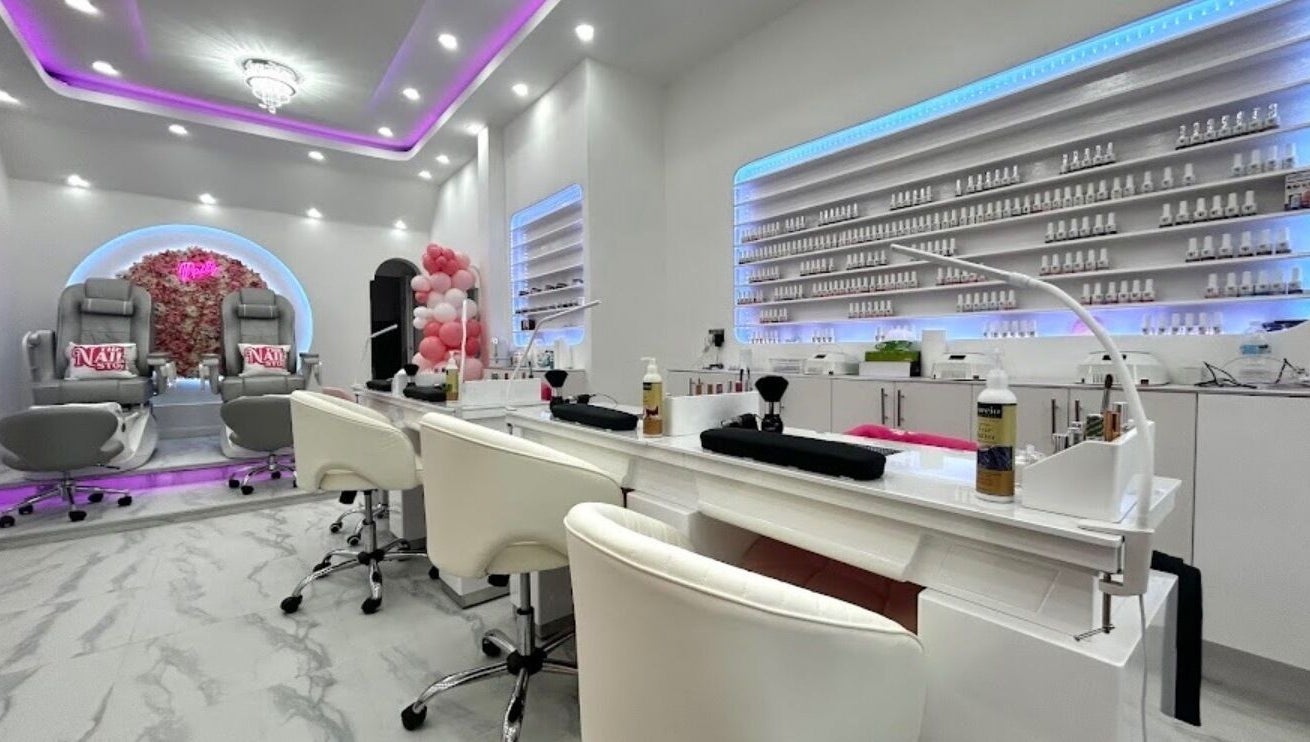 Elegant interior of The Nail Stop in Oldbury, England, GB, featuring plush pedicure chairs and ambient lighting.