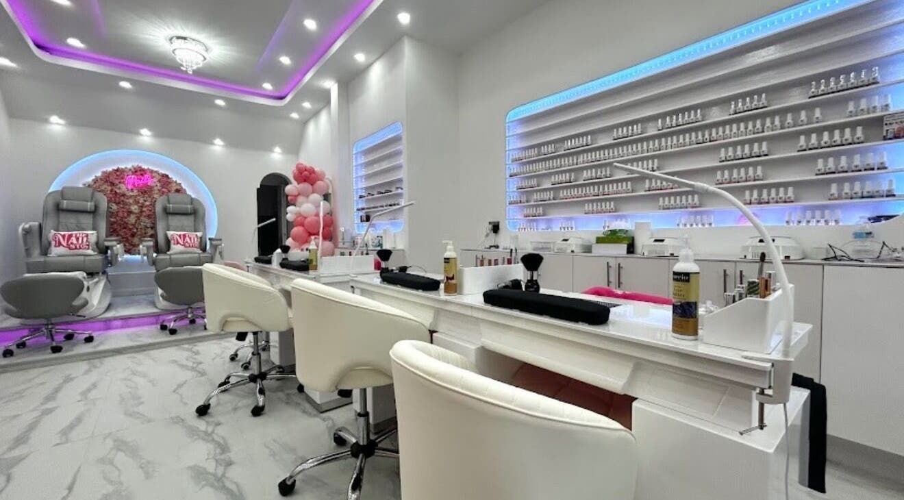 Elegant interior of The Nail Stop in Oldbury, England, GB, featuring plush pedicure chairs and ambient lighting.
