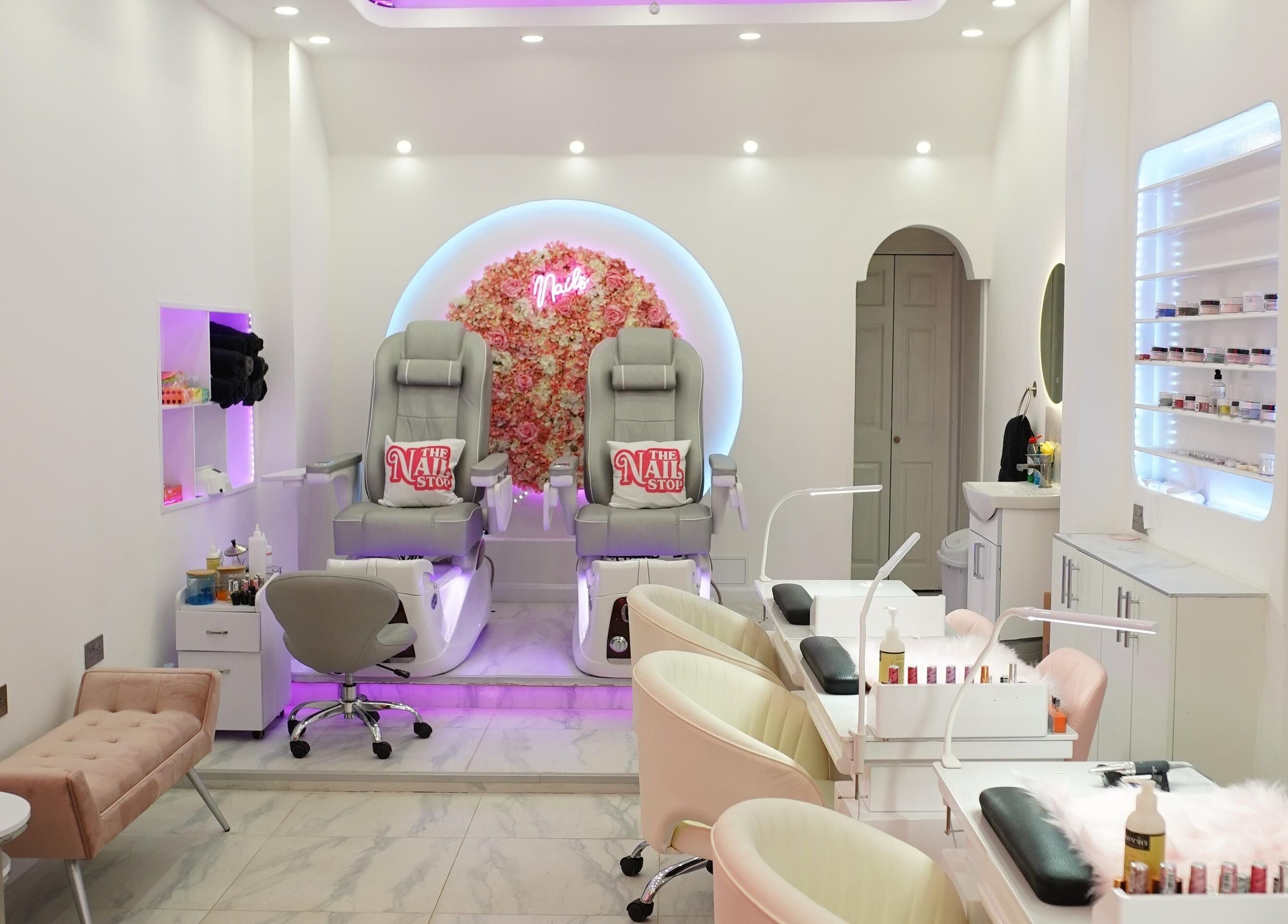 Elegant interior of The Nail Stop, Oldbury, England, GB featuring plush pedicure chairs and stylish decor.