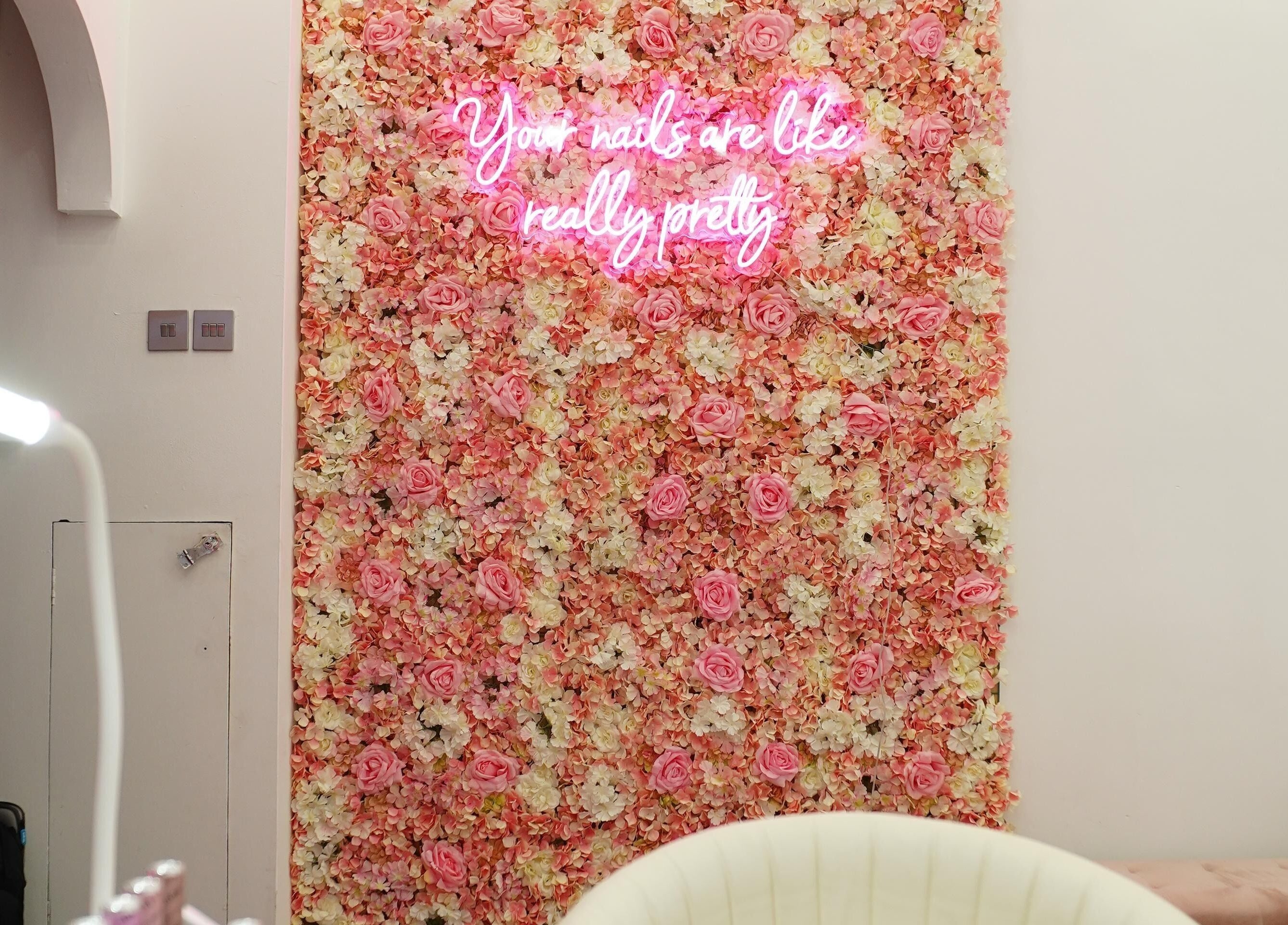 Floral wall with neon sign at The Nail Stop, Oldbury, England, GB. Perfect for a stylish salon experience.