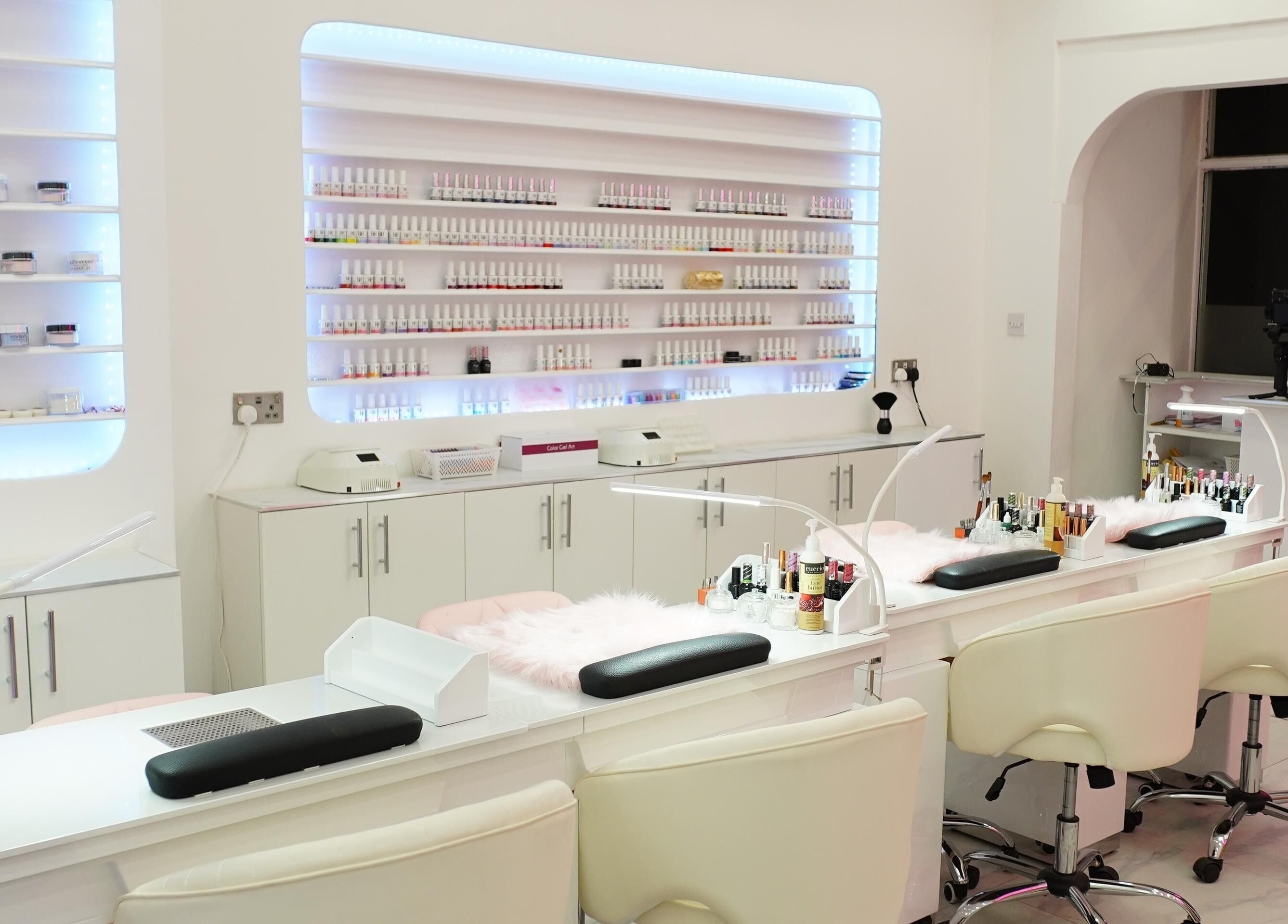 Elegant interior of The Nail Stop in Oldbury, England, GB, featuring stylish nail polish displays and plush seating.