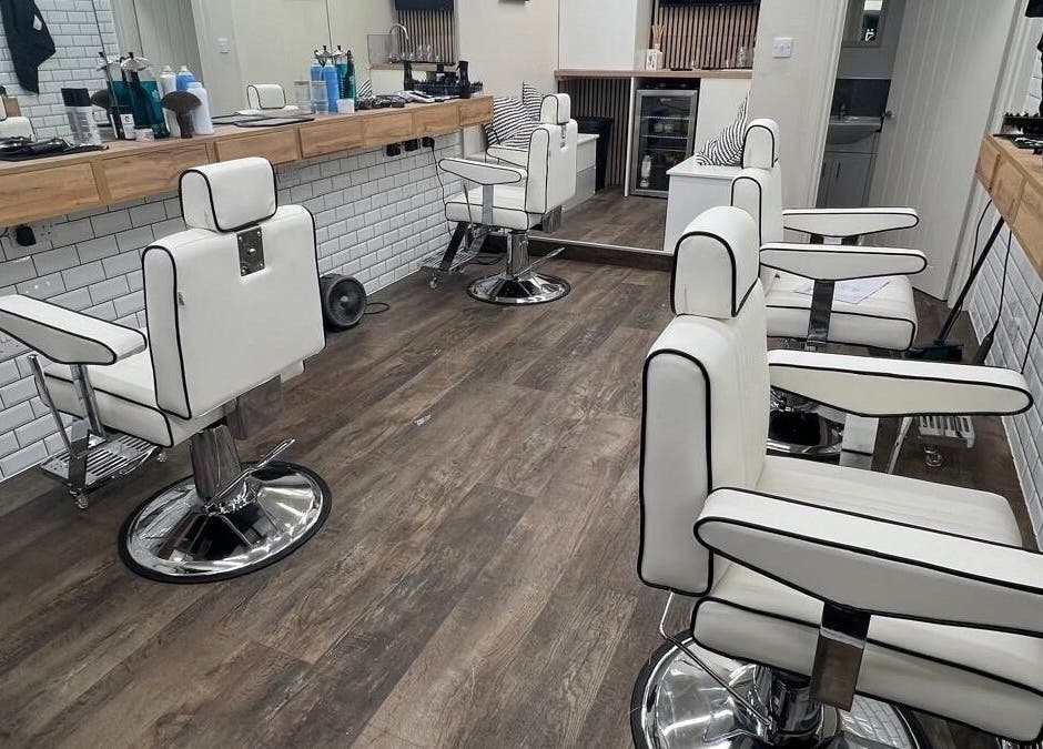 Modern barber chairs and sleek interior design at Atelier Barber Co, Bearsden, Scotland, GB.