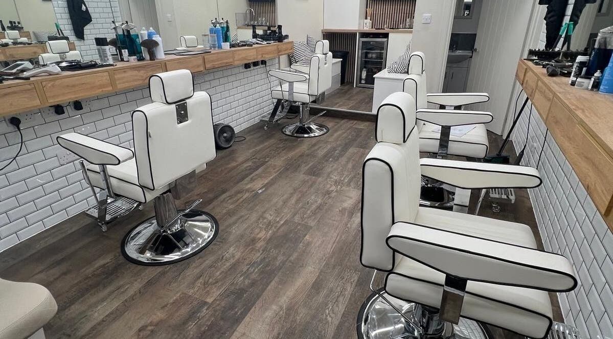 Modern barber chairs and sleek interior design at Atelier Barber Co, Bearsden, Scotland, GB.