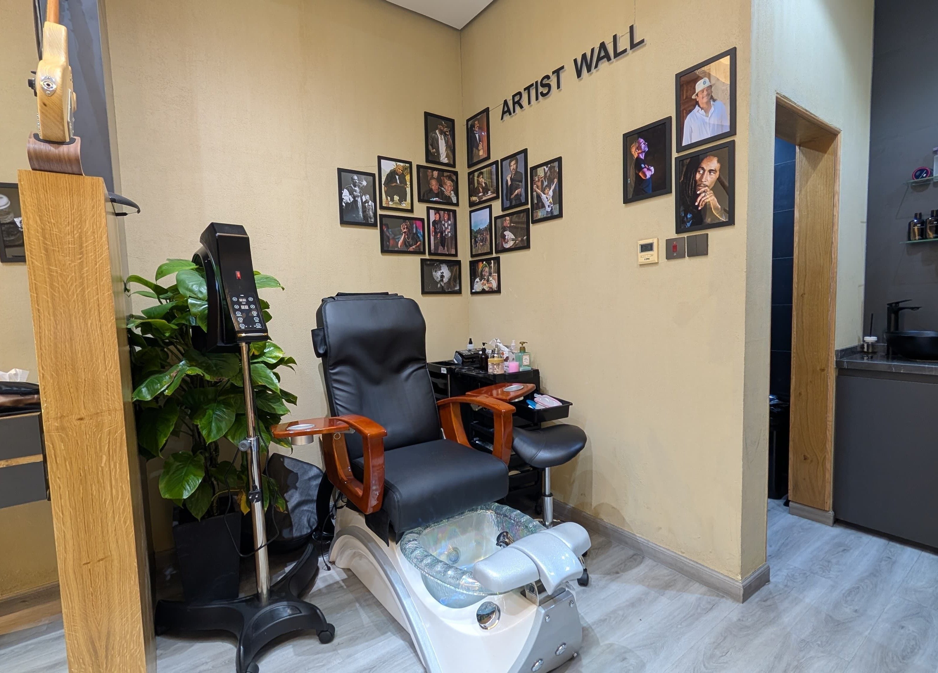 Modern pedicure chair and artist wall at Bab Al Rayyan Gents Salon, Dubai, AE.