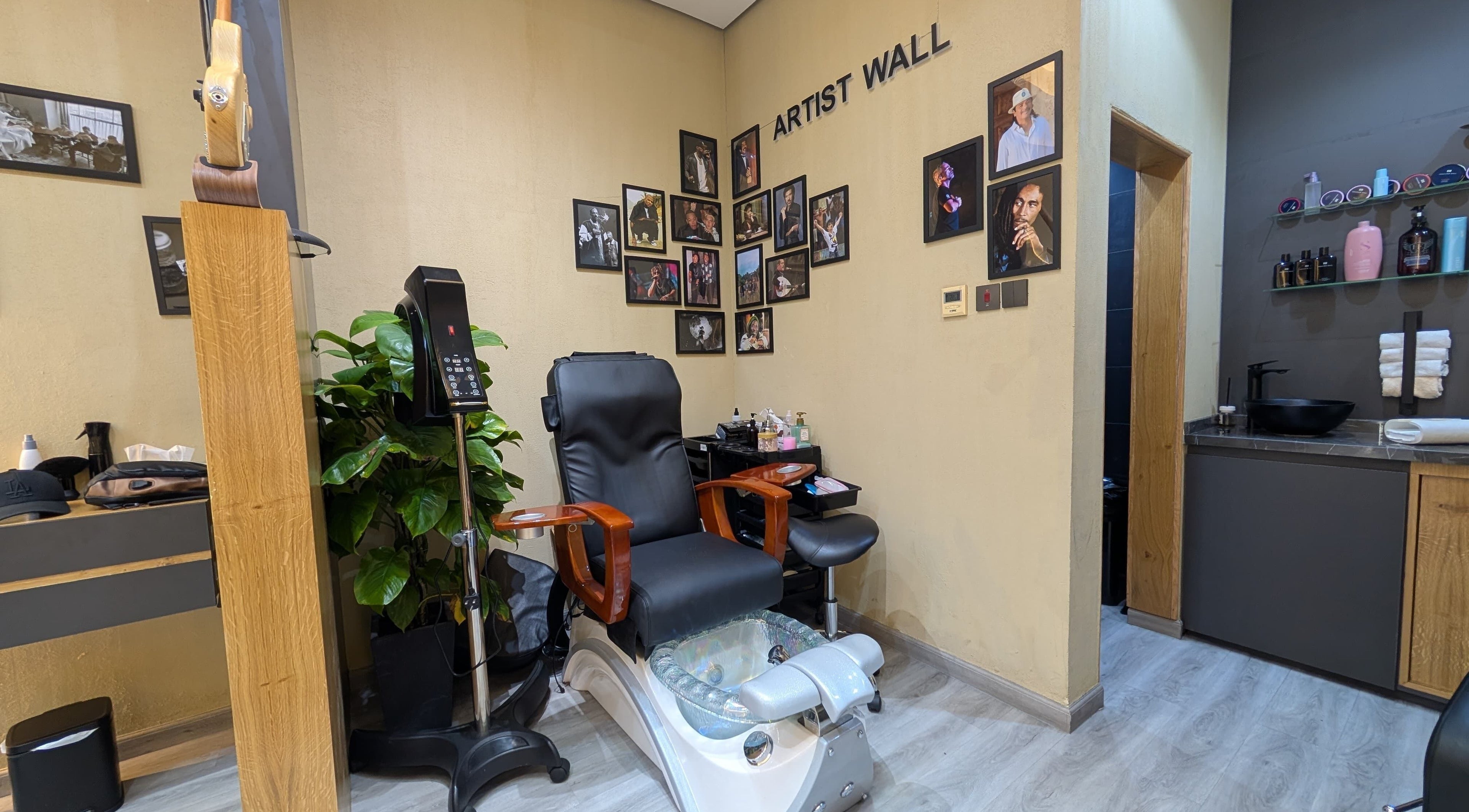 Modern pedicure chair and artist wall at Bab Al Rayyan Gents Salon, Dubai, AE.