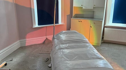 Serene treatment room at Sea View Beauty, Poole, England, GB, with a massage table and soft lighting.