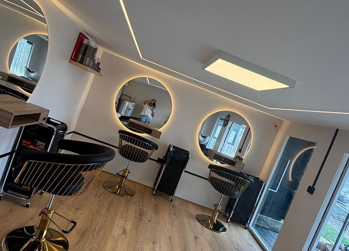 Stylish salon setup at RML Studios, Brentwood, England, GB featuring modern round mirrors and sleek chairs.