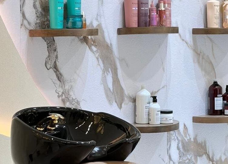 Elegant hair wash station at صالون مكحال, Riyadh, Riyadh Province, SA, with premium products on display.