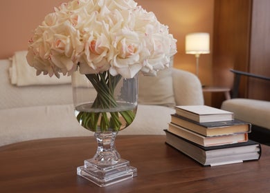Elegant vase with white roses and books decorates Penelope Gomes Beauty, Il-gżira, MT.