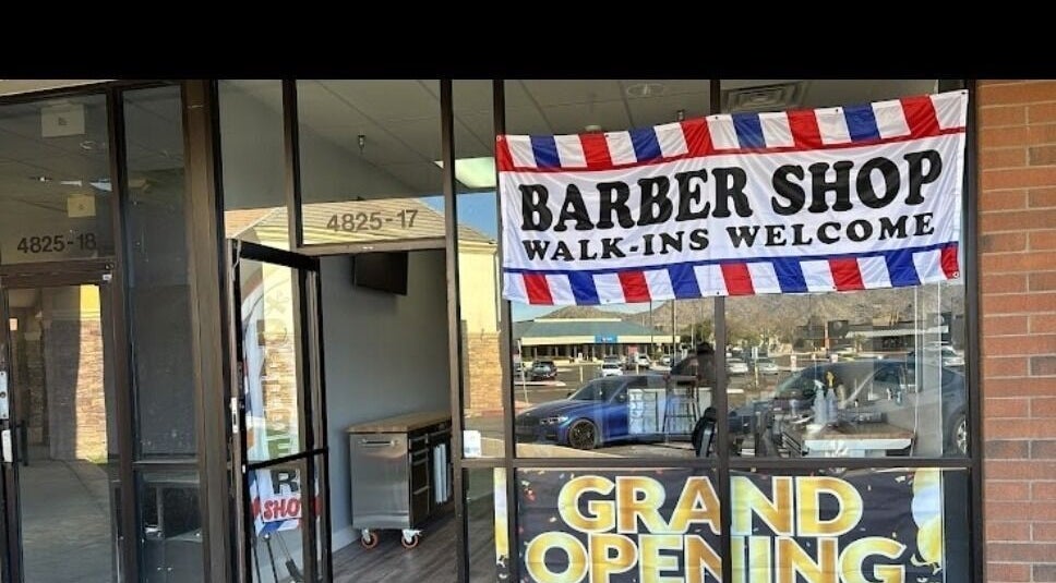 Grand opening at Emg Barbershop in Phoenix, Arizona, US with welcoming signs and modern interior.