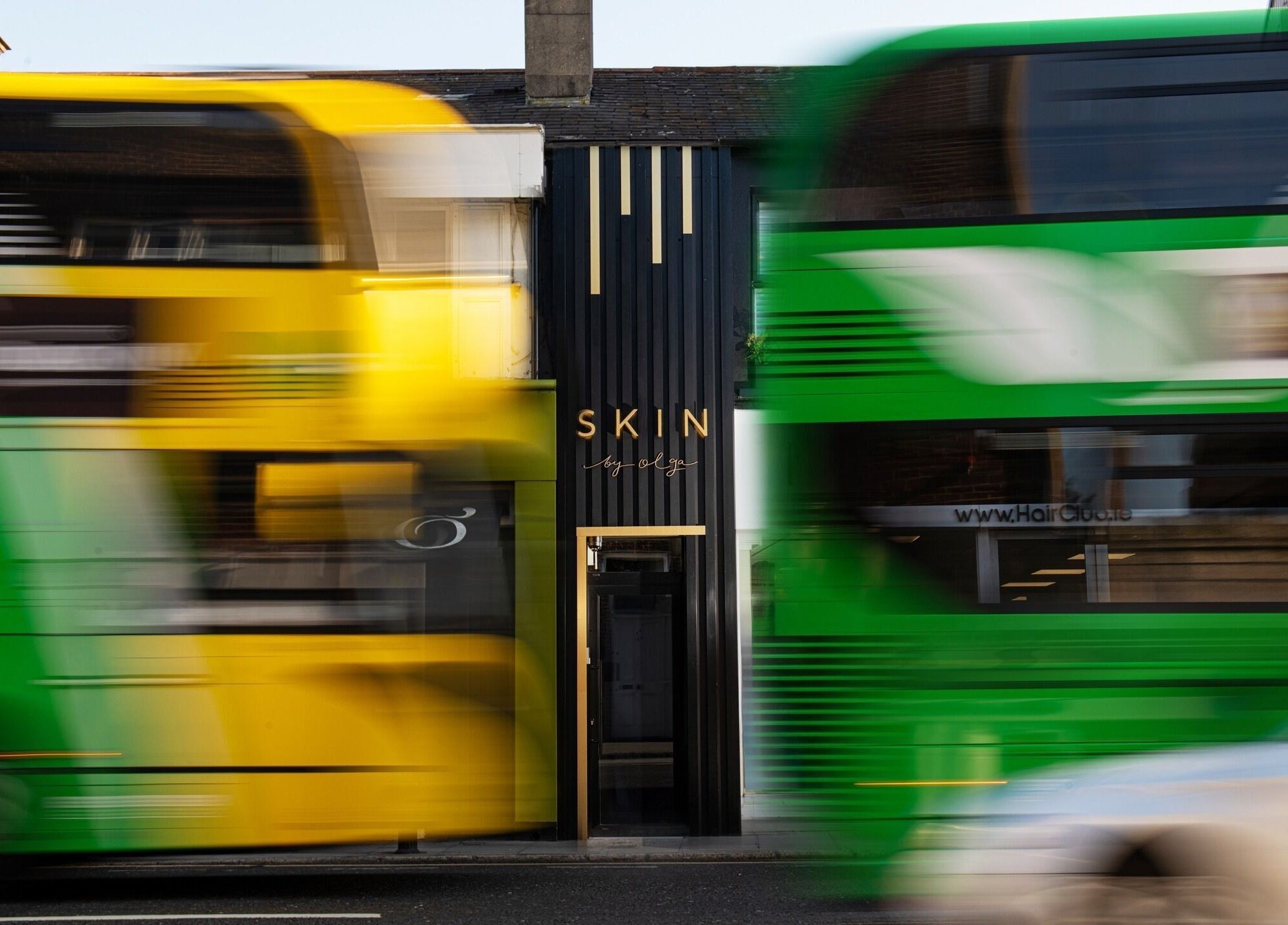 Skin By Olga facade with vibrant buses passing by, Dublin, County Dublin, IE.