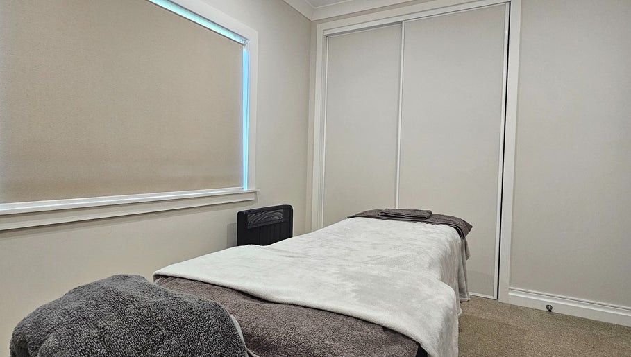 Tranquil massage room at Qi Harmony Massage, Normanby, Taranaki, NZ, featuring a comfy massage table.