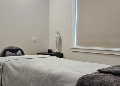 Peaceful massage room at Qi Harmony Massage, Normanby, Taranaki, NZ, featuring a cozy treatment bed.