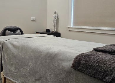 Tranquil massage room at Qi Harmony Massage, Normanby, Taranaki, NZ, featuring a comfortable massage table.