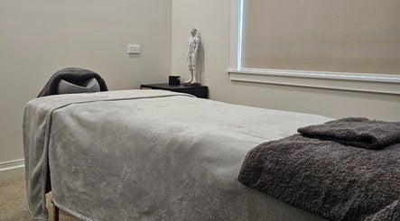 Tranquil massage room at Qi Harmony Massage, Normanby, Taranaki, NZ, featuring a comfortable massage table.