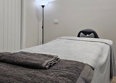 Tranquil massage room at Qi Harmony Massage, Normanby, Taranaki, NZ featuring a comfortable massage table.