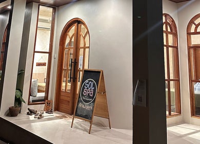 Entrance of Sol Spa Gili, located in Nusa Tenggara Barat, ID, showcasing inviting arched windows and open sign.