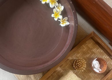 A calming spa setup with flowers and accessories at Sol Spa Gili, Nusa Tenggara Barat, ID.