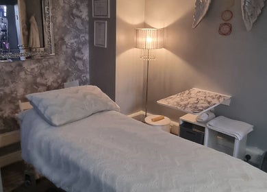 Cozy treatment room at The Healing Room Oldham, Lees, England, GB with plush bed and ambient lighting.