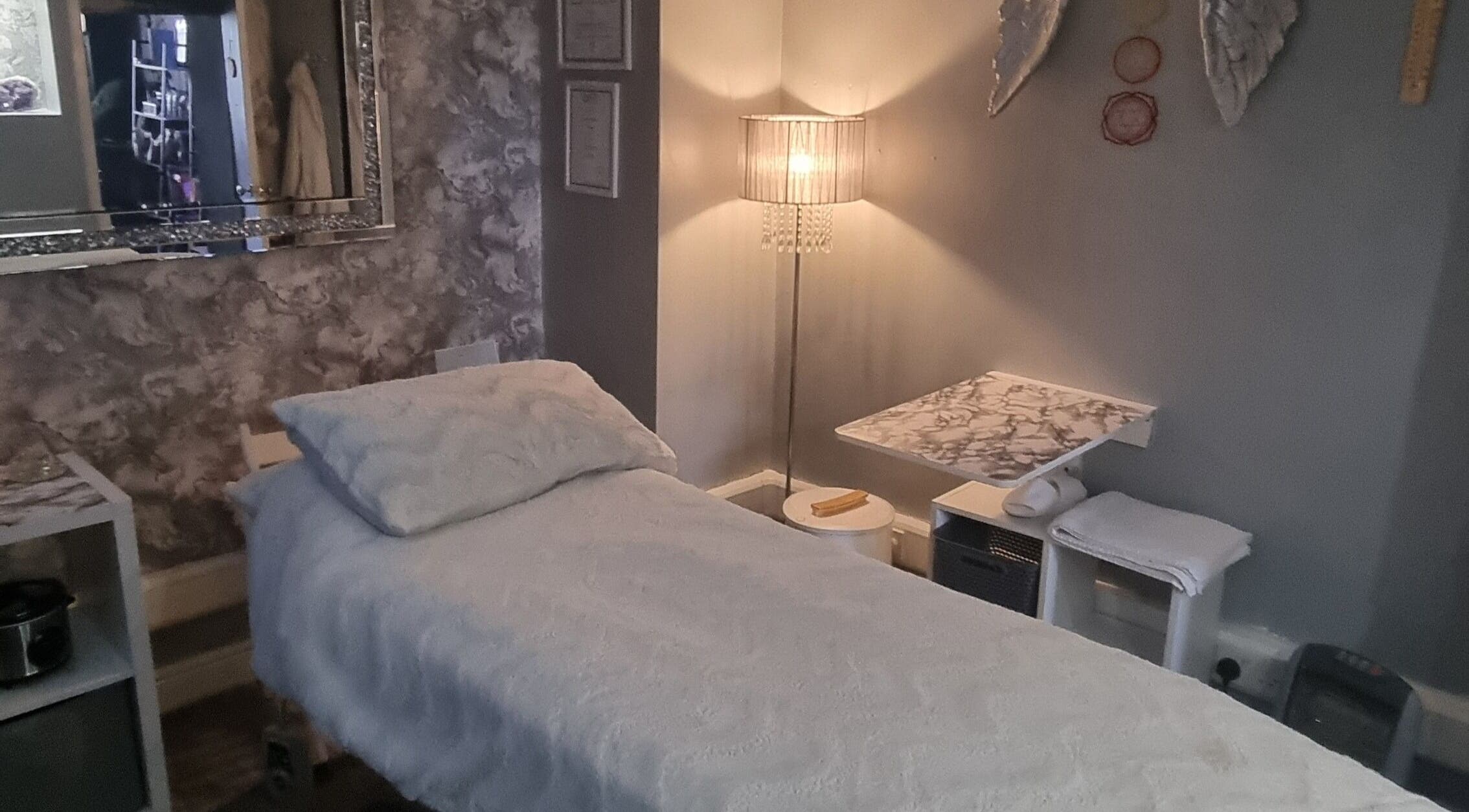 Comfortable spa treatment room at The Healing Room Oldham in Lees, England, GB with serene lighting.