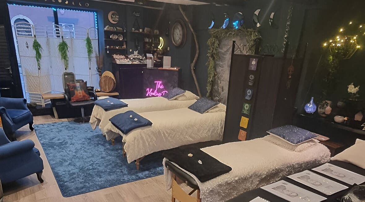 Calm interior of The Healing Room Oldham, England, GB, featuring massage beds and ambient lighting.
