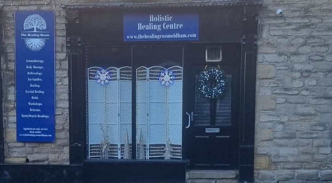 Front of The Healing Room Oldham, a holistic center in Oldham, England featuring festive decor and signage.