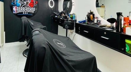 Modern interior of NBA Barbershop Bonaire in Kralendijk, showcasing sleek chairs and grooming tools.