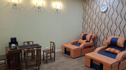 Relaxing lounge area at Angels Wellness Spa, Perth, Western Australia, AU, featuring plush seating and elegant decor.