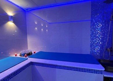 Relaxing massage area at Glamsoul Beauty Lounge, Abu Dhabi, AE, illuminated by calming blue lights.
