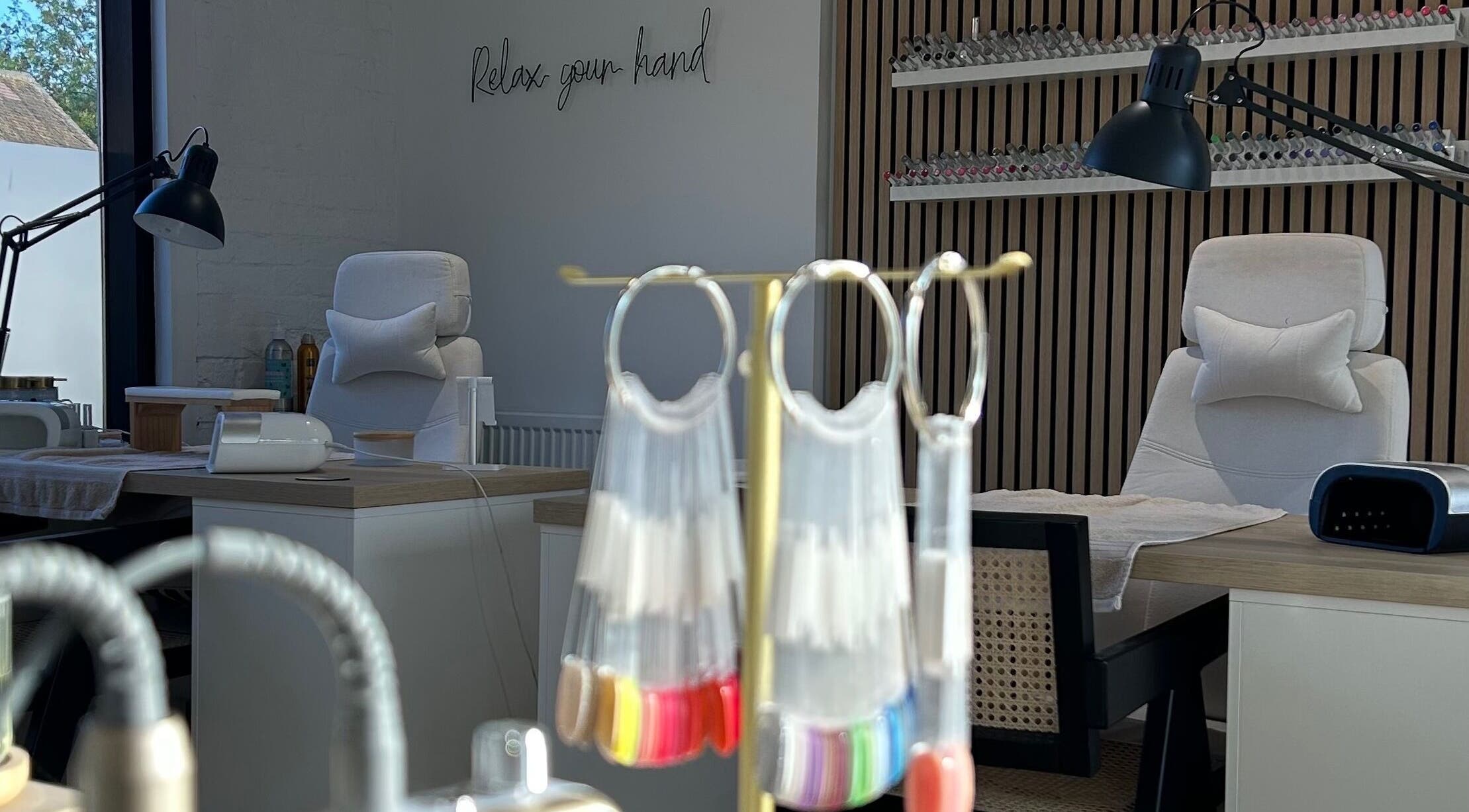 Modern nail salon interior at Polished By Em, Polesworth, England, GB with nail polish displays and manicure stations.