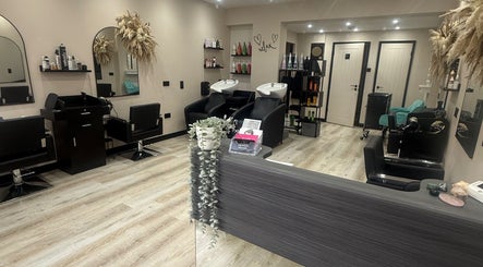 Modern interior of THE STYLIST Hair Studio in Stockport, England, GB, featuring elegant styling and washing stations.
