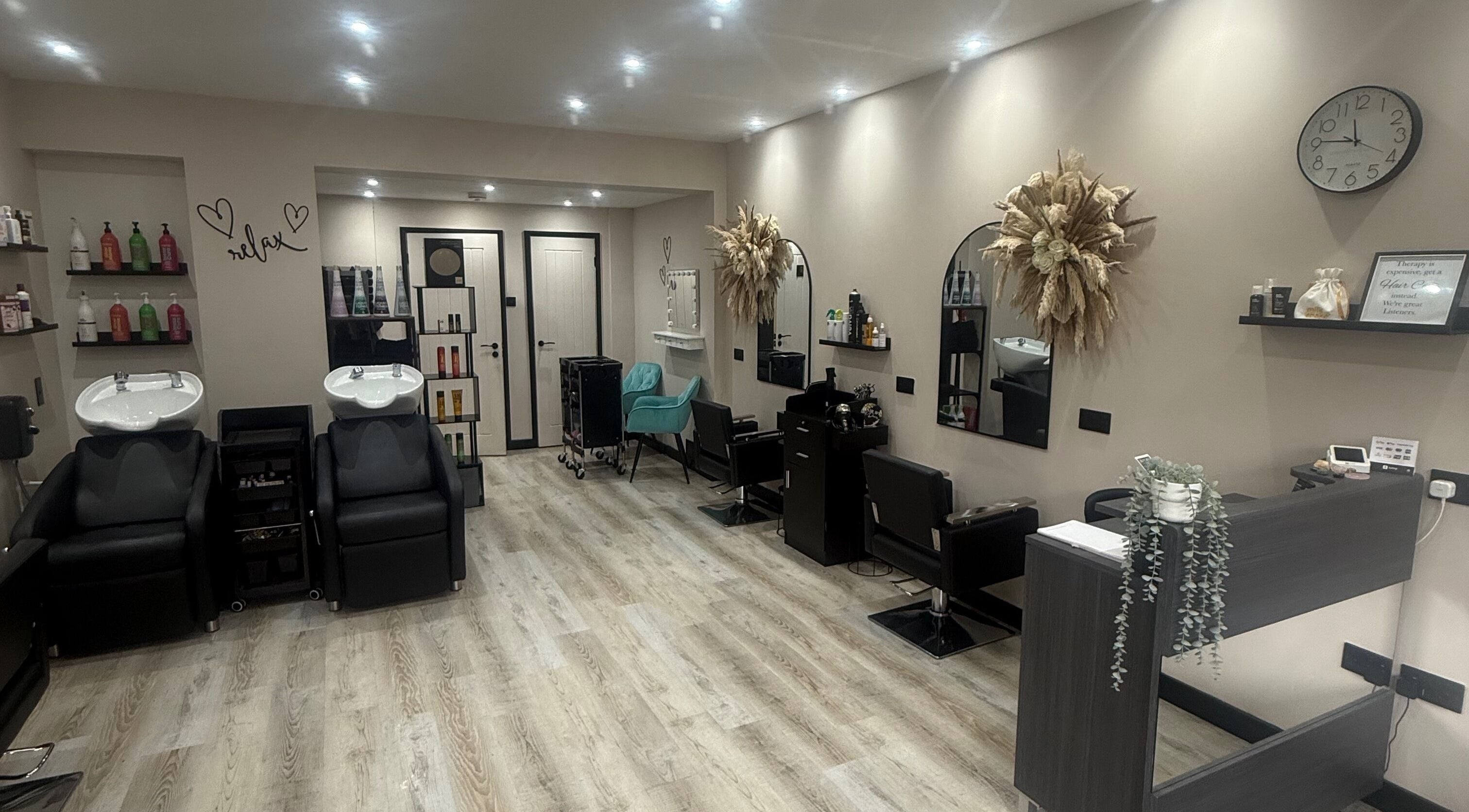 Modern interior of The Stylist Hair Studio in Stockport, England, GB featuring chic wash stations and elegant decor.