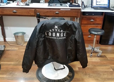Inside Style Lounge Hairdressing and Barbering, Melbourne showing a stylish jacket on a barber chair.