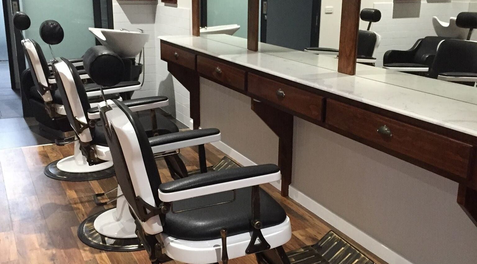 Barber chairs at Style Lounge Hairdressing and Barbering, Melbourne, Victoria, AU with a sleek, modern design.