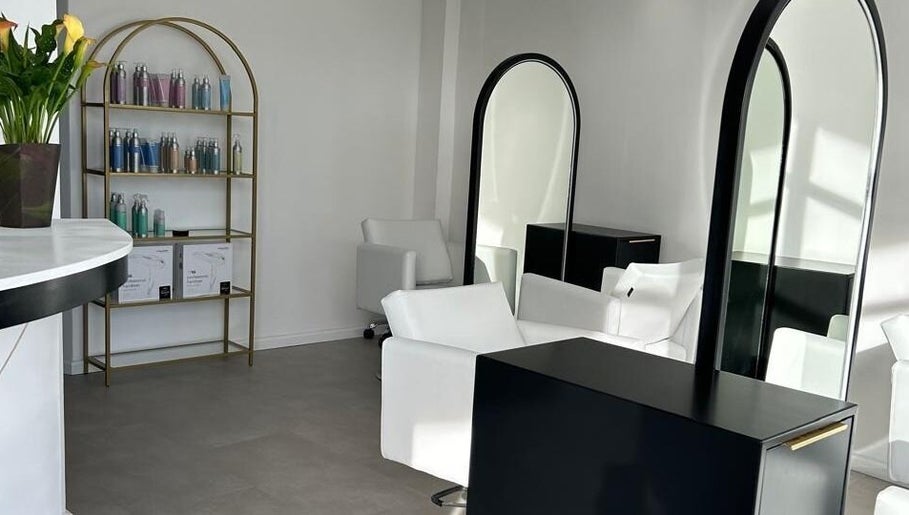 Modern salon interior at Alchemy Hair & Beauty, Cape Town, Western Cape, ZA. Elegant mirrors and chairs.
